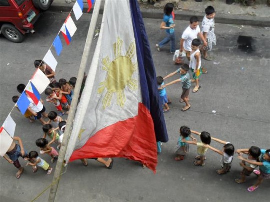 Philippine Flag over Playing Kids
